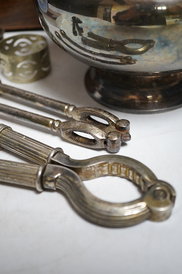 A Regency rosewood tea caddy, three pairs of nut crackers including a novelty skull nut cracker, a plated bowl, two napkin rings and a Wedgwood dish. Condition - varies